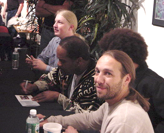 Derek, Yonrico and Todd smile and sign CDs at IMAC on 6/11/04.